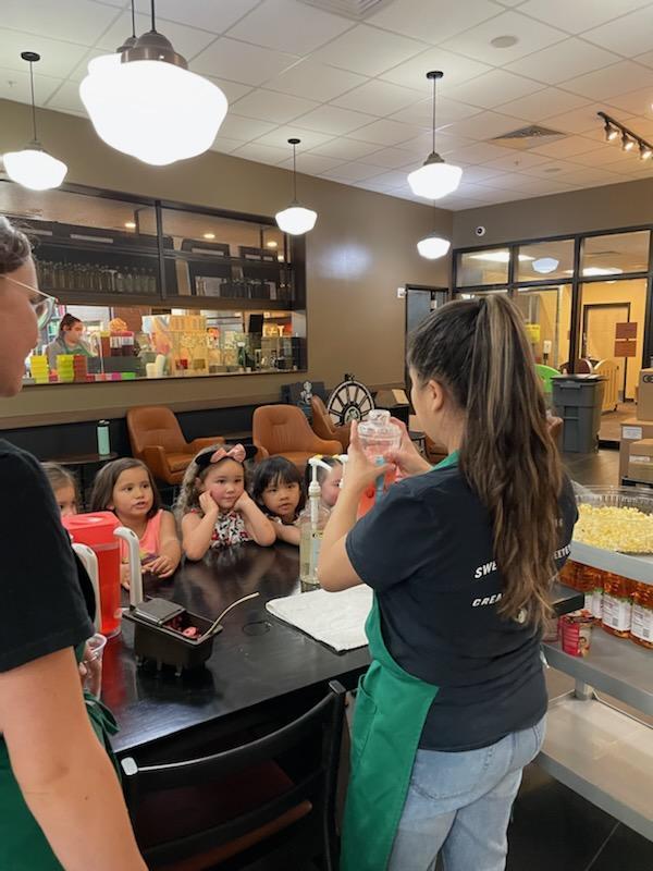 Baristas showing the preschoolers how they make drinks