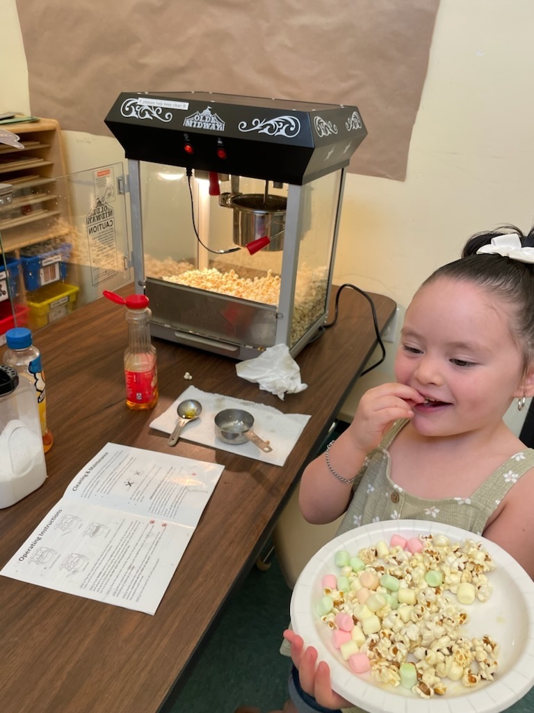 preschooler tasting her popcorn