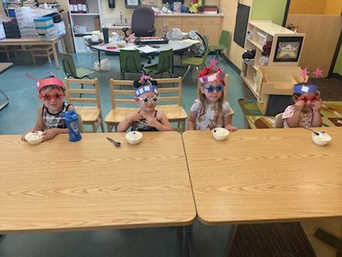 preschoolers showing their ice cream and hats they made