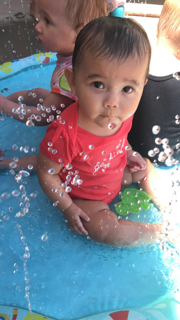 Infant enjoying the water outside