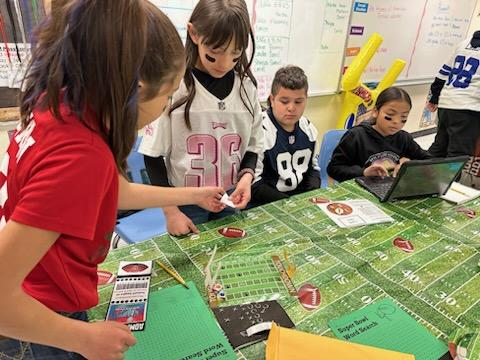 Students are playing a game at their football table.