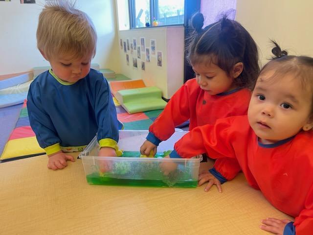Toddlers playing with jello for sensory 